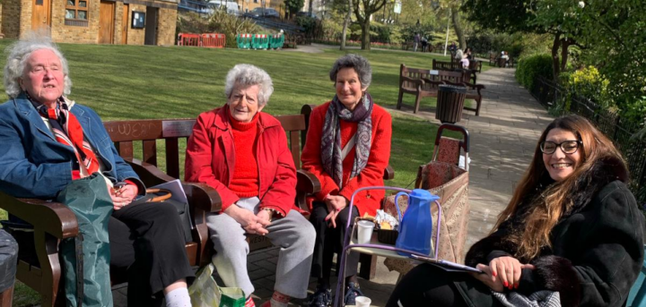 Women reading poetry outdoors