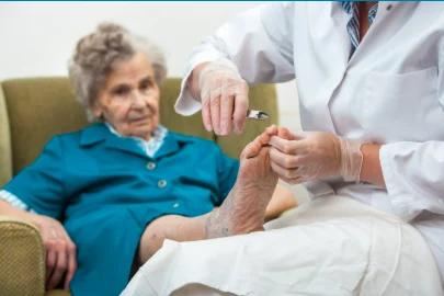 Podiatrist providing footcare to an older woman