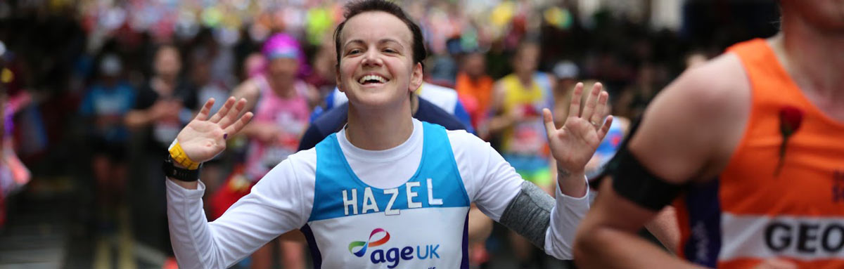 A runner celebrating at the finish line
