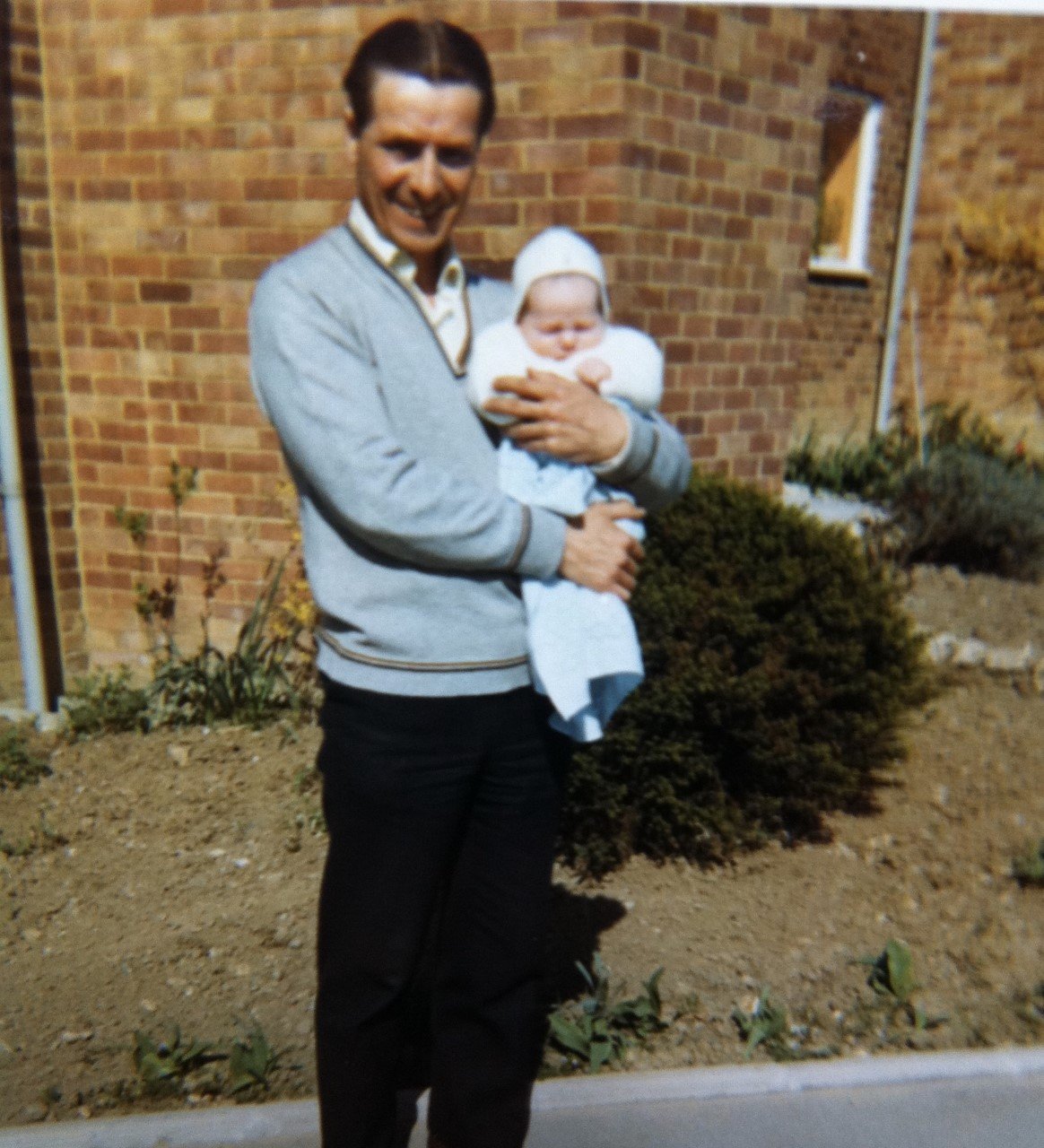 An older man, Ernie, holding a baby