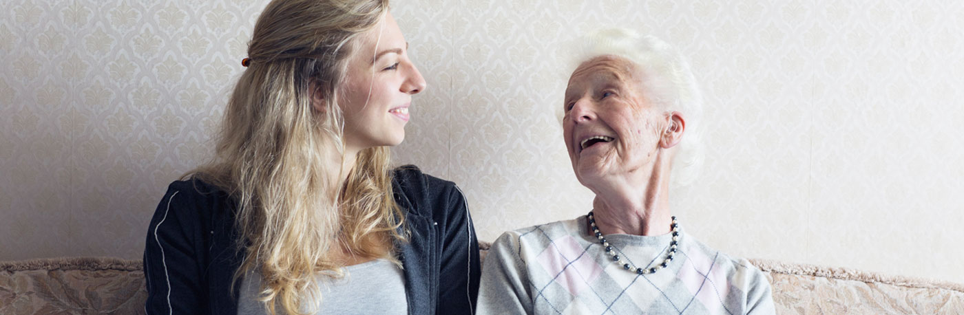 Older person getting help from carer