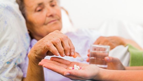 Older woman taking medication