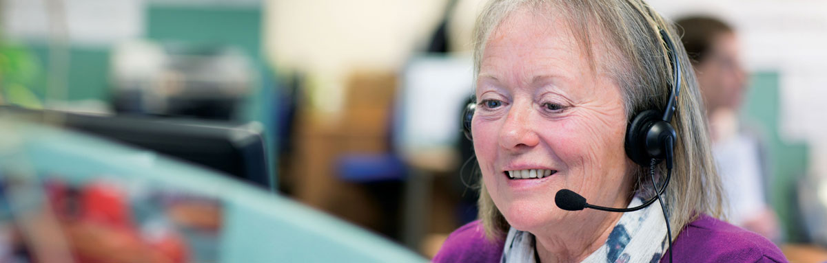 An Age UK team member answers a call