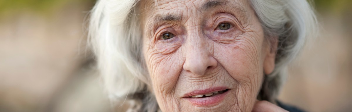 An older woman smiles at the camera