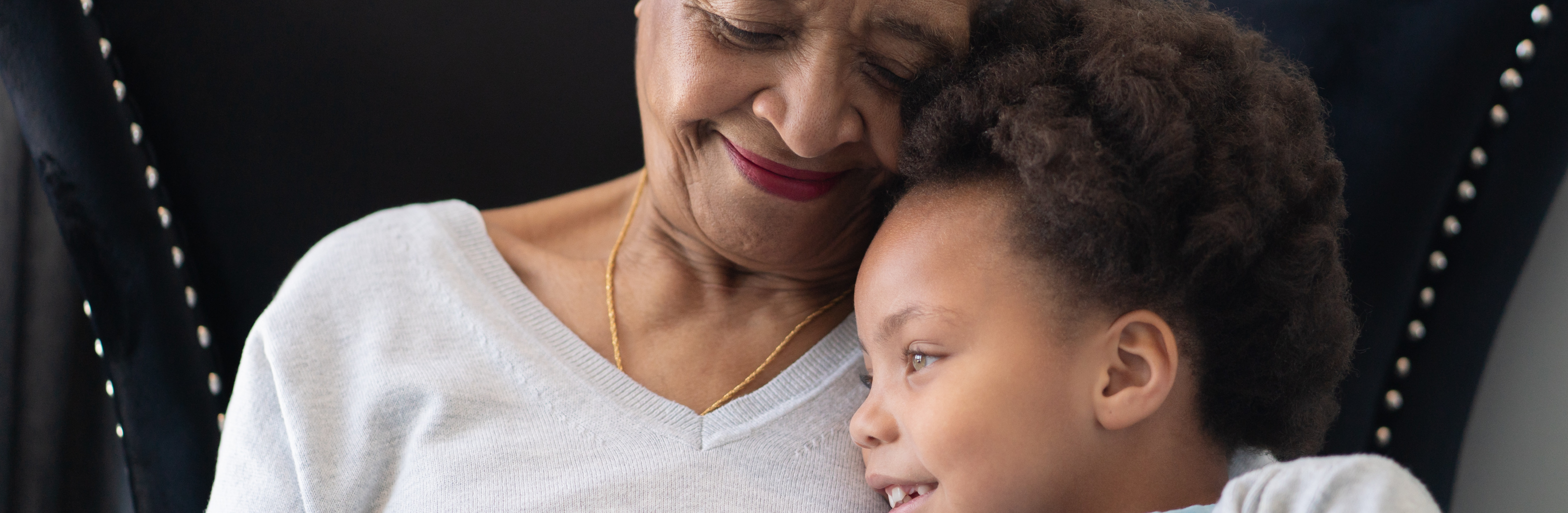 A grandmother and grandson cuddle