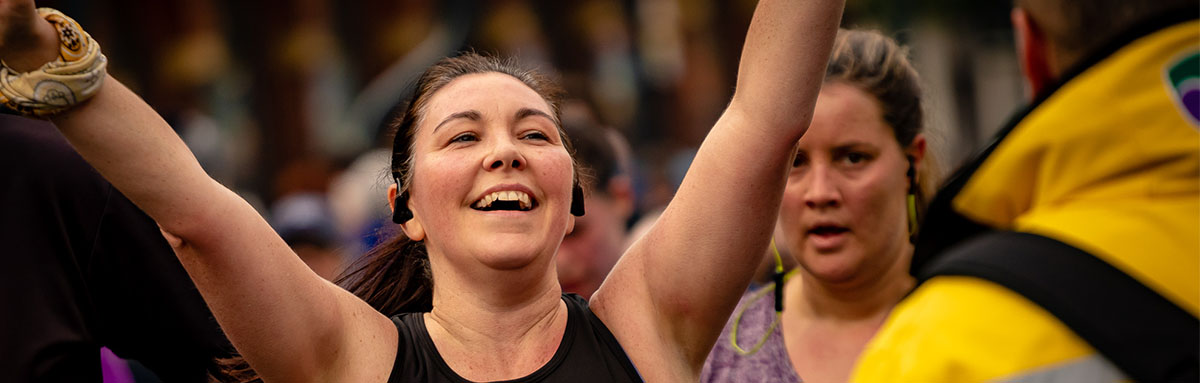 A woman celebrates as she crosses the finishing line