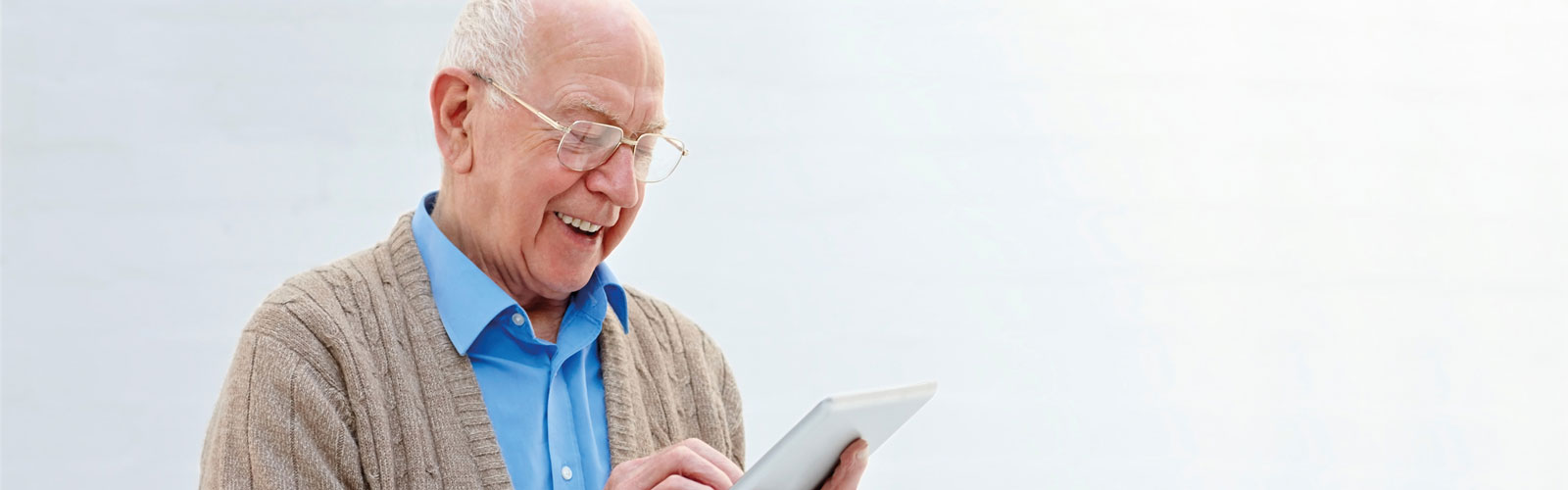 An older man using a tablet