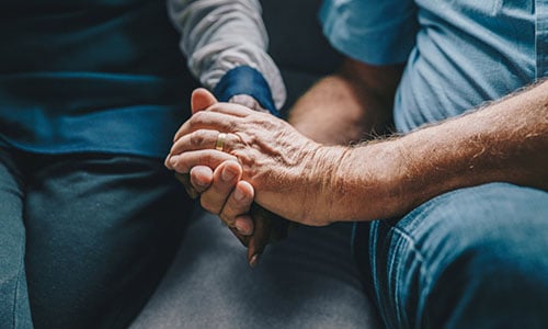 Two people holding hands