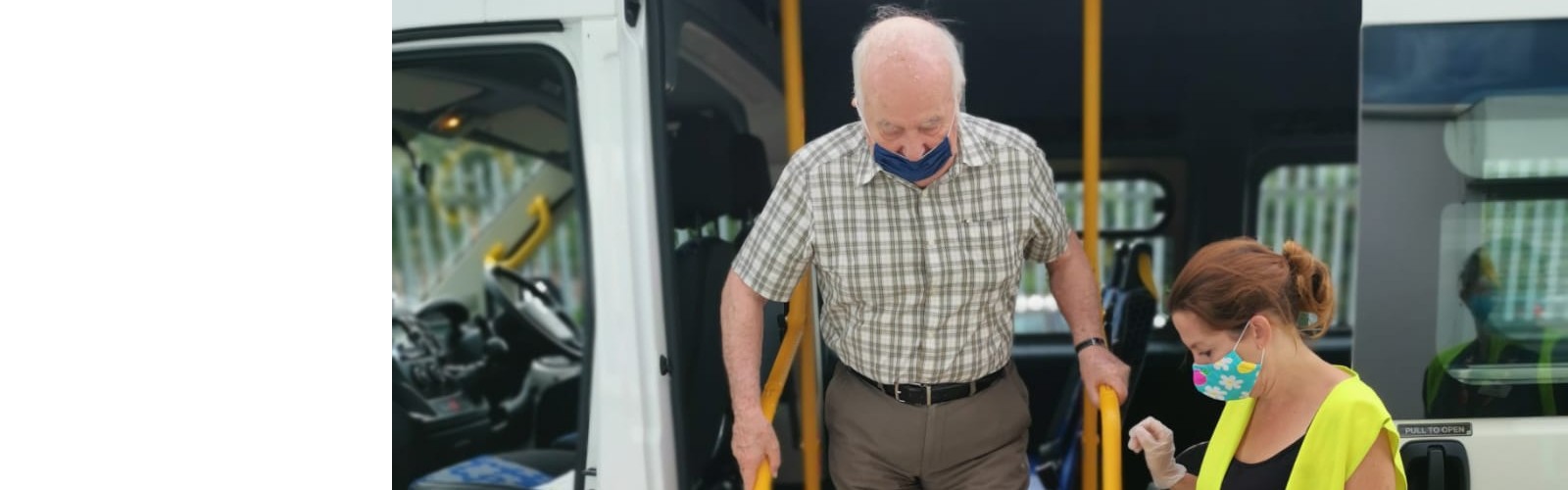 An older man steps out of an Age UK Medway vehicle