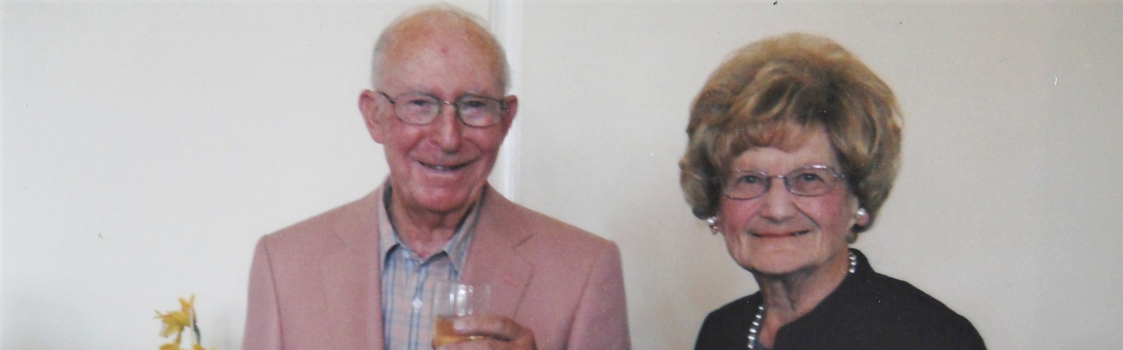 An older couple, smiling at the camera