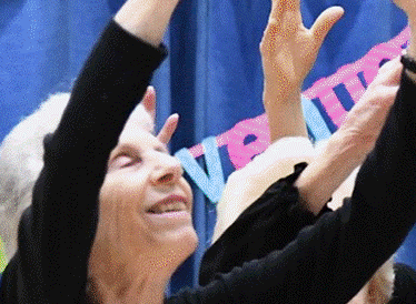 A group of women, dressed in black, dancing together