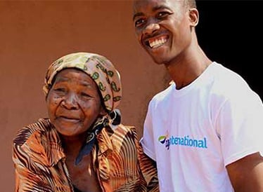 Age International staff working with a lady in Mozambique