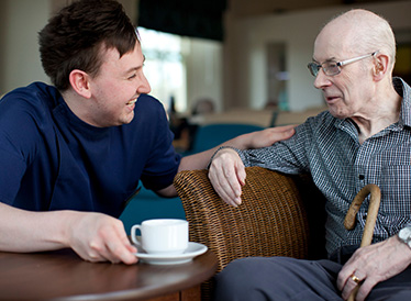 A young man and an older man chatting