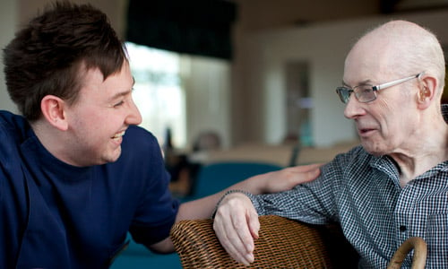 An older and young man speaking