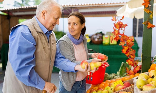 People shopping at vegetable stall