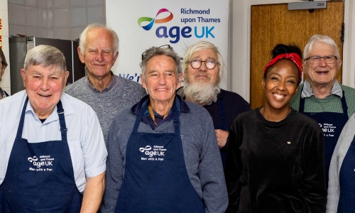 Presenter Angellica Bell smiles with a group of older men at a class in Age UK Richmond upon Thames