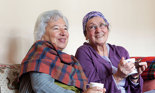 Two older women sit together