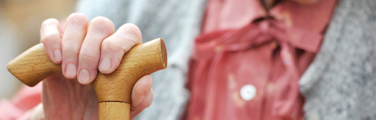 Older woman using walking stick