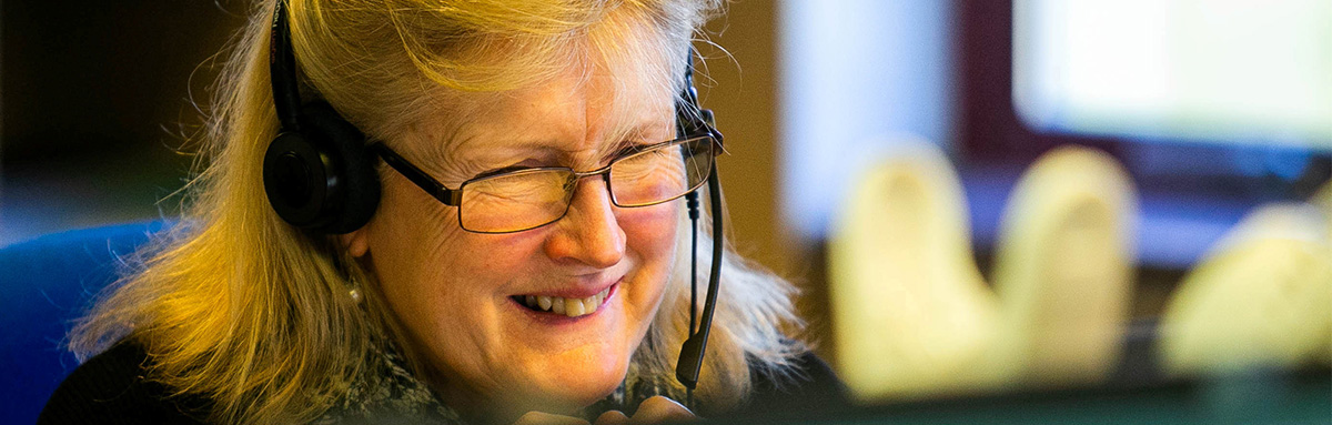 An Age UK adviser answers a call