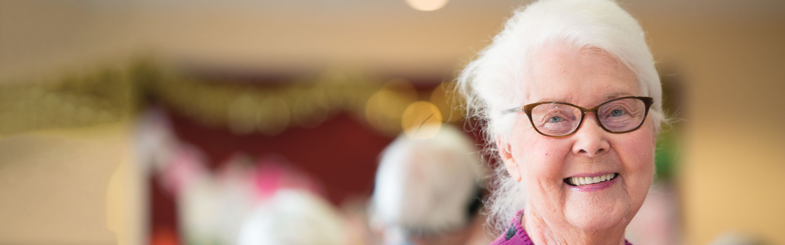 Lady in purple smiling at the camera