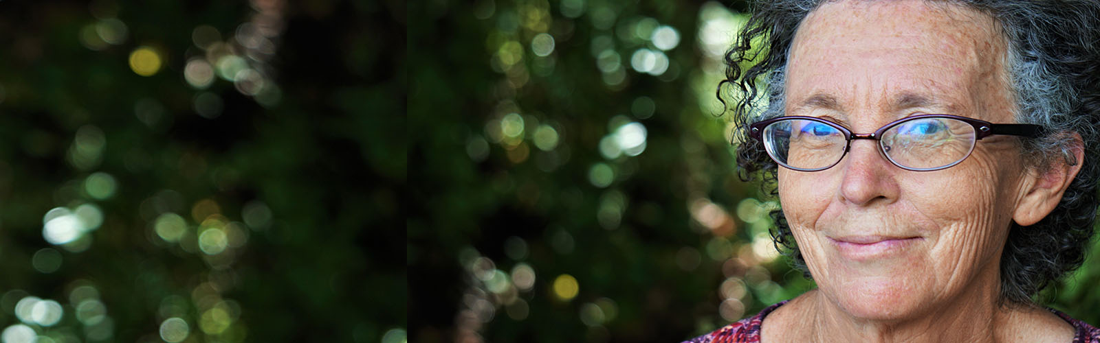 An older lady wearing glasses looks at the camera