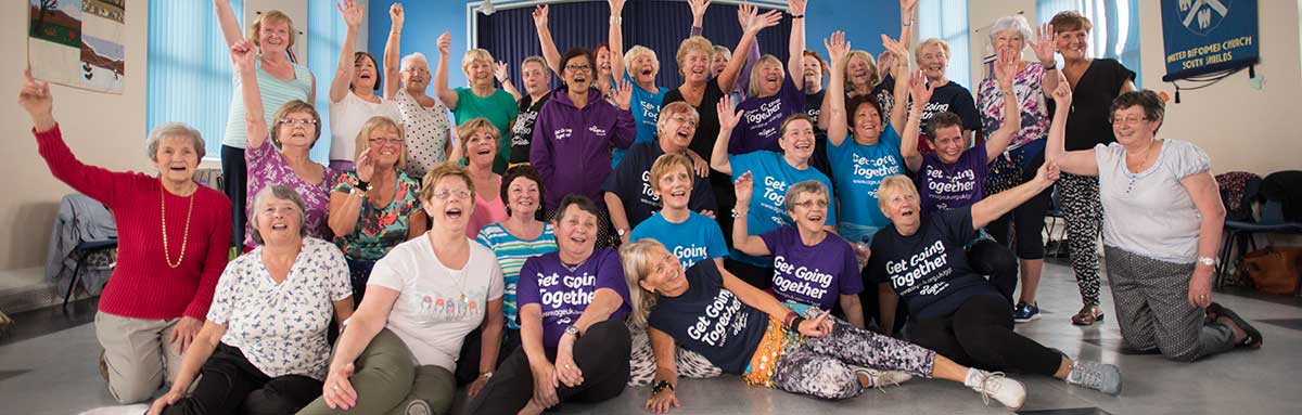 Group of excited Age UK volunteers