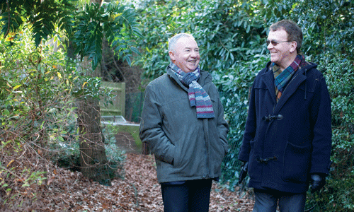 two men talking in a forest