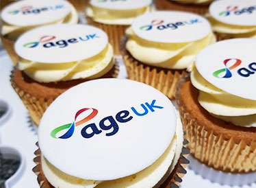 CUpcakes in gold foil with Age UK logo on top