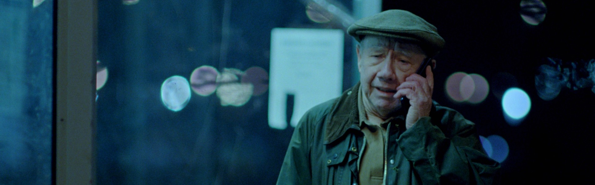 An older man phones someone at night