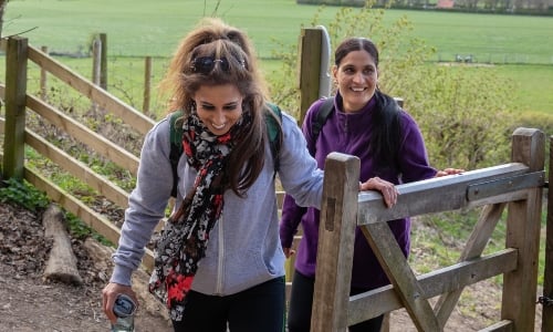 Two women walking through the countryside