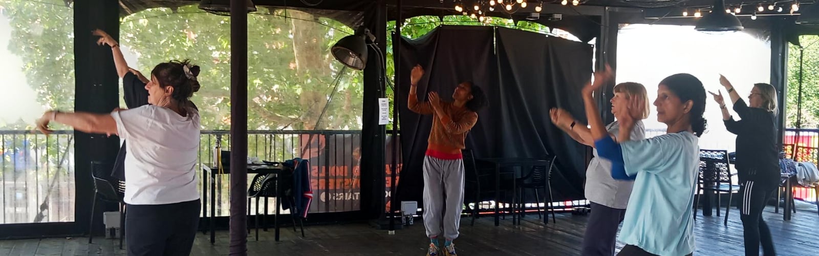 A group of older women doing Bollywood dance moves