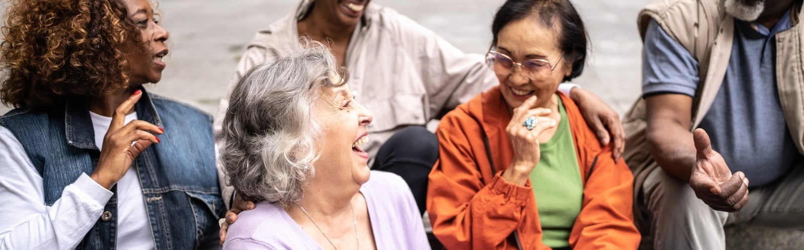 A group of older people, laughing together