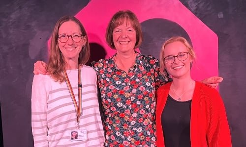 Three women smiling at the camera