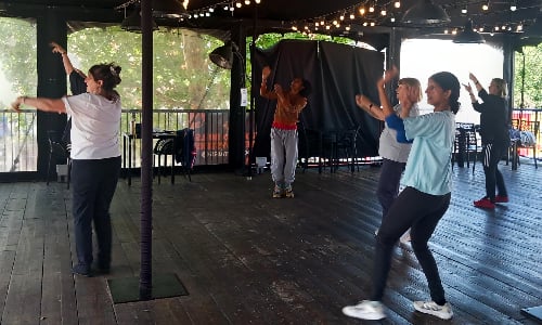 A group of older women doing Bollywood dance moves