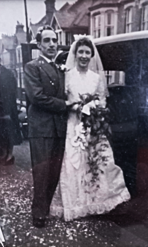 A black-and-white photo of a young couple on their wedding day