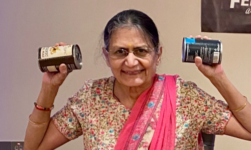 An older woman working out using tinned goods
