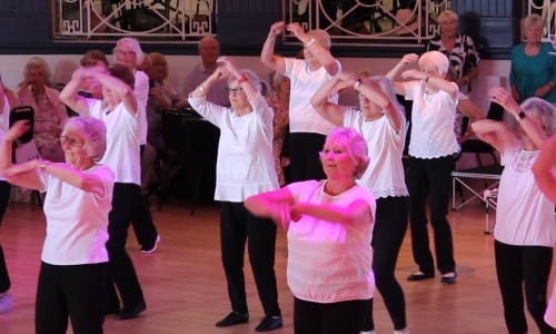 A group of older women dancing