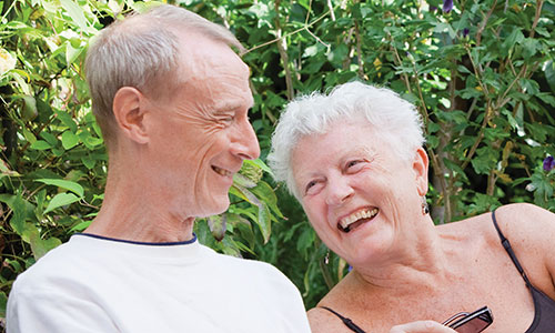 An older man and woman, laughing together
